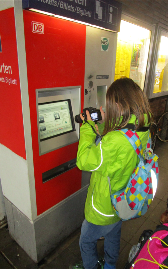 Ein Kind fotografiert einen Ticket-Automaten